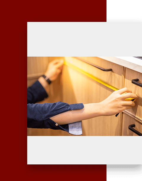 A person holding on to the handle of a kitchen cabinet.