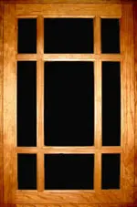 A wooden window frame with black glass in the center.